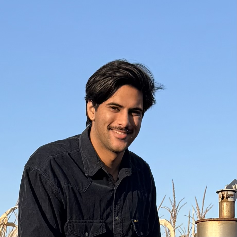 Gyan Prayaga in a corn field against a blue sky